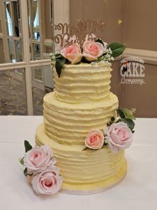 three-tier ribbed wedding cake with fresh pink flowers - tamworth