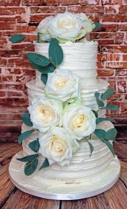 three-tier ribbed buttercream wedding cake fresh white roses - Tamworth