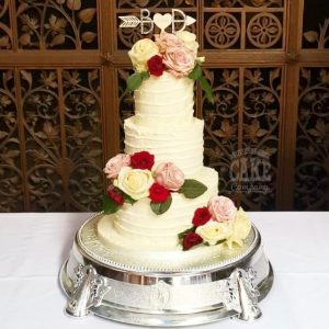 three-tier ribbed buttercream wedding cake fresh red pink roses - Tamworth