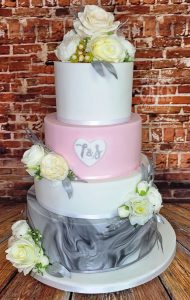 four-tier pink and grey marble wedding cake silk flowers - Tamworth