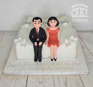 60th anniversary couple sitting on cake - Tamworth