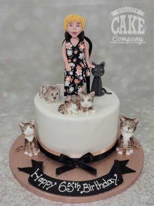 Lady sitting with her cats birthday cake - Tamworth