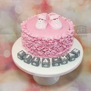 new baby pink ruffles booties and blocks christening cake - Tamworth