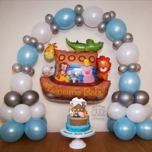 Two tier Noah's ark theme baby shower cake matching balloons - Tamworth