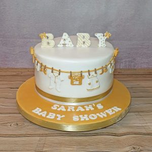 Baby shower washing line neutral white and gold cake - Tamworth