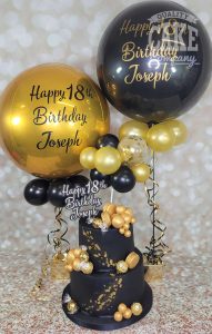 two tier black and gold modern ball birthday cake plus matching balloons - tamworth
