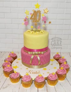 two tier pink and yellow quilted birthday cake with cupcakes - tamworth