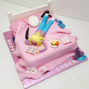 girl lying on bed birthday cake - Tamworth