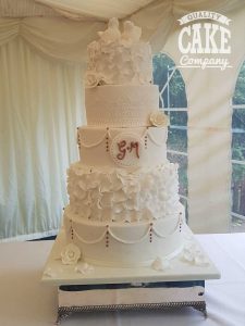 Five tier large ruffle swag lace wedding cake with rose gold touches and doves Tamworth West Midlands Staffordshire