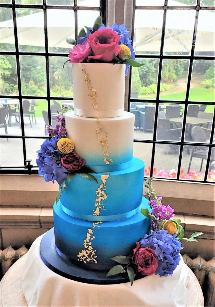 Bright blue four tier ombre wedding cake gold leaf fresh flowers Tamworth West Midlands Staffordshire