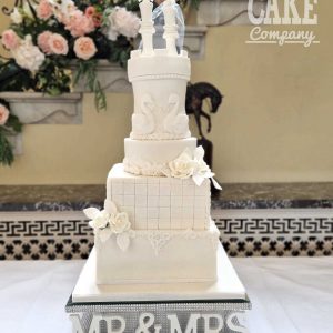 Beautiful four tiered chess and swan themed wedding cake
