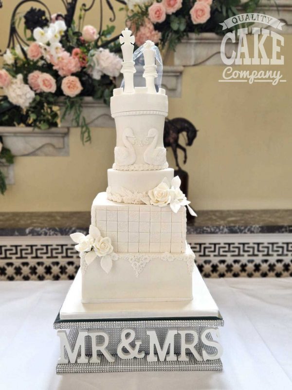 Beautiful four tiered chess and swan themed wedding cake