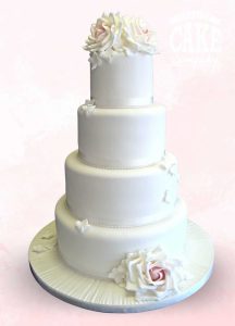 All white four tier wedding with roses and petals Tamworth Staffordshire West Midlands