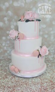 three tier white wedding with pink drip roses and macarons - tamworth