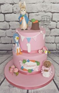 two tier peter rabbit and friends first birthday cake pink - Tamworth