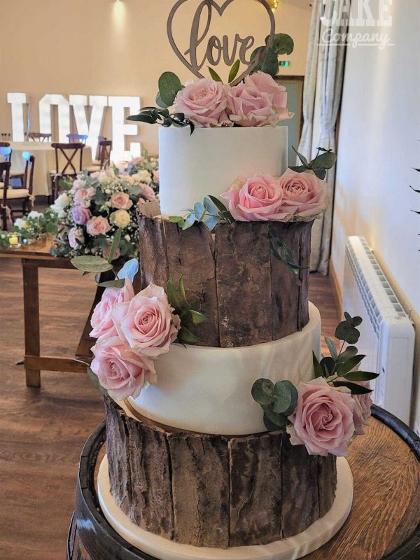 Rustic Bark and white four tier cake with fresh roses and wooden love topper at venue coton house Tamworth West Midlands Staffordshire