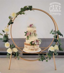 Semi naked three tier wedding cake in large gold hoop stand Tamworth West Midlands Staffordshire