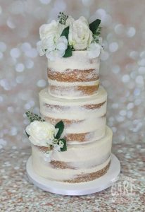 three tier semi naked wedding cake with white silk flowers - Tamworth west midlands