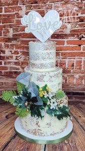 three tier small semi naked wedding cake with foliage - Tamworth