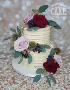 two tier ribbed buttercream wedding cake with fresh flowers and berries - tamworth