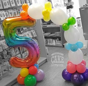 children's 5th birthday rainbow table balloon arch - Tamworth