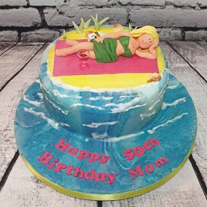 lady lying on beach theme cake - tamworth