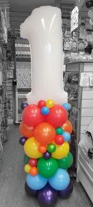 white and rainbow first birthday balloon column - Tamworth