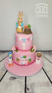 two tier peter rabbit and friends pink birthday cake - Tamworth