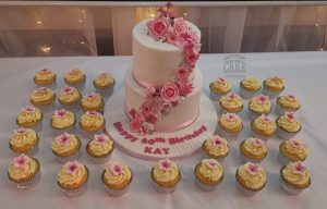 two tier pink floral cascade with matching cupcakes - Tamworth
