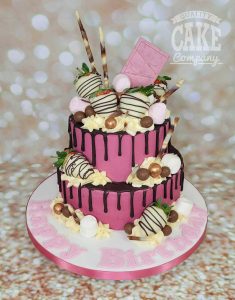 two tier bright pink chocolate strawberry drip cake - tamworth