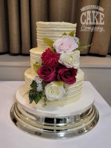 three tier ribbed buttercream wedding cake with bright silk flowers - tamworth west midlands