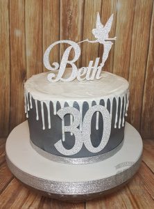 silver and white drip cake with tinkerbell topper - Tamworth