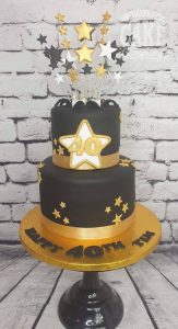 two tier black and gold starburst cake - Tamworth