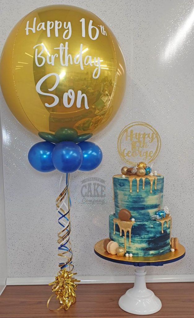 two tier modern blue and gold drip cake with matching balloon - tamworth