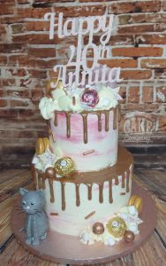 two tier rose gold drip cake with cat - tamworth