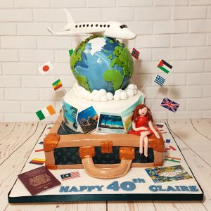 two tier travel theme cake with world - Tamworth