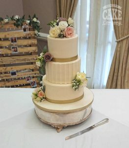 Ivory stripe wedding cake gold ribbons and fresh flowers Tamworth West Midlands Staffordshire
