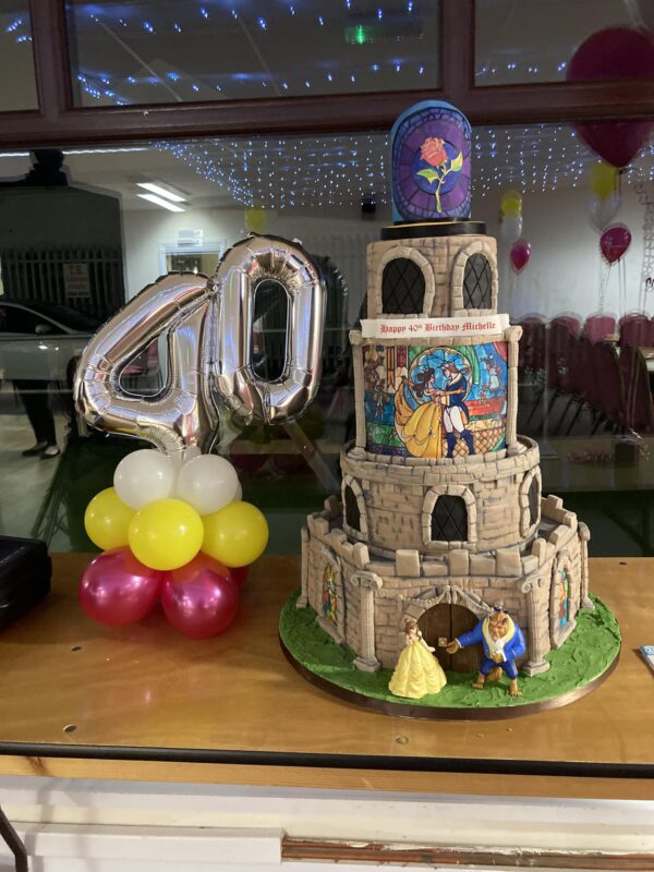 5 tier Beauty and Beast birthday cake with 40 balloon display