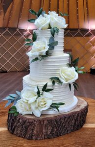 Fresh roses decorating a three tier wedding cake