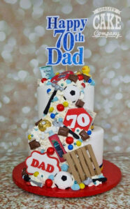 two tier cascade of treats hobby theme birthday cake