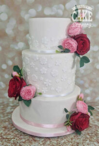 three tier white floral wedding cake