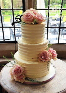 three tier ribbed wedding cake with fresh roses - tamworth