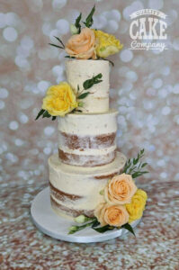 small three tier semi naked wedding cake with fresh flowers - tamworth