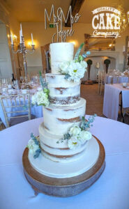 four tier small semi naked wedding cake with fresh flowers - Tamworth