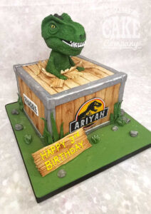 t-rex in a crate kids jurassic park themed birthday cake