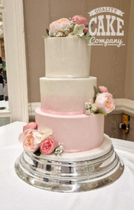 three tier pink ombre wedding cake with silk peonies