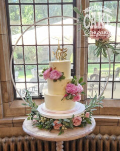 three tier buttercream wedding cake with fresh peonies