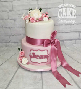 two tier pink and white floral 60th birthday cake