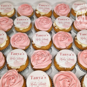 mixture of printed and swirl cupcakes for a baby shower in pink