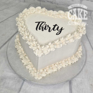 white heart shaped piped modern thirtieth birthday cake